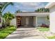 Attached carport with extra storage shelving at 601 42Nd Ne Ave, St Petersburg, FL 33703