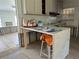 The partially renovated kitchen has sleek countertops, ample cabinet space, and a breakfast bar with seating at 601 42Nd Ne Ave, St Petersburg, FL 33703
