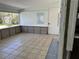 A partially renovated sunroom offers a bright, airy space with tile flooring and large windows at 601 42Nd Ne Ave, St Petersburg, FL 33703