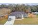 Gray house with a fenced yard, driveway, and car at 6103 Fairway Dr, Ridge Manor, FL 33523