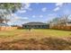 Spacious backyard with wooden fence and a fire pit area at 6103 Fairway Dr, Ridge Manor, FL 33523