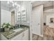 Stylish bathroom features granite countertops, updated vanity, and access to other rooms at 6103 Fairway Dr, Ridge Manor, FL 33523