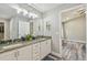 Bathroom with double vanity, granite countertop and a view of another room at 6103 Fairway Dr, Ridge Manor, FL 33523
