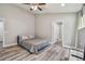 Spacious bedroom featuring wood-look floors and ceiling fan at 6103 Fairway Dr, Ridge Manor, FL 33523