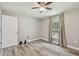 Bright bedroom with wood-look floors, ceiling fan, and a window with backyard view at 6103 Fairway Dr, Ridge Manor, FL 33523
