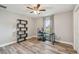 Cozy bedroom featuring a home office setup and wood-look floors at 6103 Fairway Dr, Ridge Manor, FL 33523