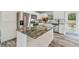 Modern kitchen with white cabinets, granite countertops, and stainless steel appliances at 6103 Fairway Dr, Ridge Manor, FL 33523