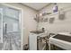 Laundry room with washer, dryer, and upper shelving at 6103 Fairway Dr, Ridge Manor, FL 33523