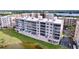 Condo building overlooking a pond with lush green surroundings at 6450 Shoreline Dr # 9203, St Petersburg, FL 33708