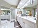 Bathroom with double vanity, shower, and mirrored closet at 6450 Shoreline Dr # 9203, St Petersburg, FL 33708