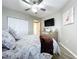 Bright bedroom featuring a king bed, dresser, and large TV at 6450 Shoreline Dr # 9203, St Petersburg, FL 33708