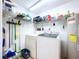 Well-equipped laundry room with washer, dryer, and storage shelves at 6450 Shoreline Dr # 9203, St Petersburg, FL 33708