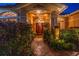 Elegant entryway with double doors, decorative lighting, and lush greenery at 800 Weathersfield Dr, Dunedin, FL 34698