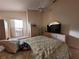 Bright bedroom with a large bed, window, and built-in dresser at 9305 Haas Dr, Hudson, FL 34669