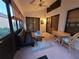 Relaxing enclosed patio with seating and a dartboard at 9305 Haas Dr, Hudson, FL 34669