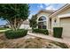 Well-maintained house exterior with manicured landscaping and walkway at 9305 Haas Dr, Hudson, FL 34669
