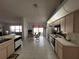Kitchen features light cabinets, tile floor and breakfast area at 9305 Haas Dr, Hudson, FL 34669