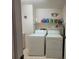 Laundry room with washer, dryer, and storage at 9305 Haas Dr, Hudson, FL 34669