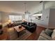 Living room with wood floors, large windows and a view of kitchen at 9305 Haas Dr, Hudson, FL 34669