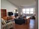 Comfortable living room featuring wood floors and a ceiling fan at 9305 Haas Dr, Hudson, FL 34669