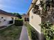 Landscaped side yard with a walkway at 9305 Haas Dr, Hudson, FL 34669