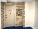 Inviting condo entry with brick accent wall and neutral door at 100 Bluff View Dr # 415A, Belleair Bluffs, FL 33770