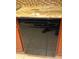 Black dishwasher in kitchen with granite countertop at 100 Bluff View Dr # 415A, Belleair Bluffs, FL 33770