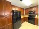Well-equipped kitchen with wood cabinets and granite counters at 100 Bluff View Dr # 415A, Belleair Bluffs, FL 33770