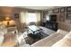 Bright living room featuring comfy sofas and a large TV at 100 Bluff View Dr # 415A, Belleair Bluffs, FL 33770