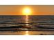 Bright orange sunset reflecting on the ocean waves at 100 Bluff View Dr # 415A, Belleair Bluffs, FL 33770