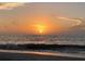 Orange sunset over ocean waves at 100 Bluff View Dr # 415A, Belleair Bluffs, FL 33770