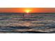 Stunning sunset over the ocean with a single post in the water at 100 Bluff View Dr # 415A, Belleair Bluffs, FL 33770