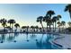 Inviting community pool with palm trees at 100 Bluff View Dr # 415A, Belleair Bluffs, FL 33770