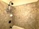Updated shower with tile surround and storage at 100 Bluff View Dr # 415A, Belleair Bluffs, FL 33770