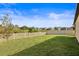 Large backyard with grassy lawn and a view at 12128 Orchid Ash St, Riverview, FL 33579