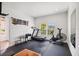 Home gym with treadmill, exercise bike, and mirror at 12128 Orchid Ash St, Riverview, FL 33579