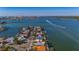 Aerial view of waterfront property situated on a tranquil waterway, surrounded by other homes and lush vegetation at 16101 6Th E St, Redington Beach, FL 33708