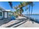 Relaxing backyard patio with waterfront views and lush tropical landscaping at 16101 6Th E St, Redington Beach, FL 33708