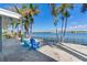 Relaxing patio overlooking waterfront with two blue chairs at 16101 6Th E St, Redington Beach, FL 33708