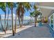 Backyard oasis with palm trees, waterfront access, and relaxing patio seating at 16101 6Th E St, Redington Beach, FL 33708
