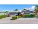 Charming stone house with lush landscaping and a brick driveway at 16101 6Th E St, Redington Beach, FL 33708