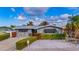 Charming stone house with lush landscaping and a brick driveway at 16101 6Th E St, Redington Beach, FL 33708