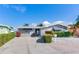 House exterior showcasing stone detailing, landscaping, and a large driveway at 16101 6Th E St, Redington Beach, FL 33708