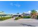 Single-story home with stone facade, spacious driveway, and well-manicured hedges at 16101 6Th E St, Redington Beach, FL 33708