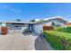 Stone house with lush landscaping and attached garage at 16101 6Th E St, Redington Beach, FL 33708