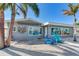 Gray house with waterfront view and blue chairs at 16101 6Th E St, Redington Beach, FL 33708