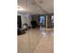 Mirrored wall reflecting stone fireplace in open living space at 2011 Auburn S St, St Petersburg, FL 33712