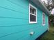 Side view of teal home with white window frames at 2716 49Th S St, Gulfport, FL 33707