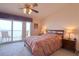 Bedroom with balcony access, complete with a ceiling fan and stylish decor at 273 Madeira Cir, Tierra Verde, FL 33715
