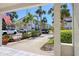 View of the community buildings from the front porch, featuring lush landscaping, parking, and attractive buildings at 273 Madeira Cir, Tierra Verde, FL 33715